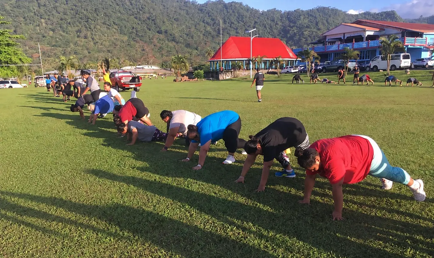 Bootcamp participants exercising together on a field in Samoa