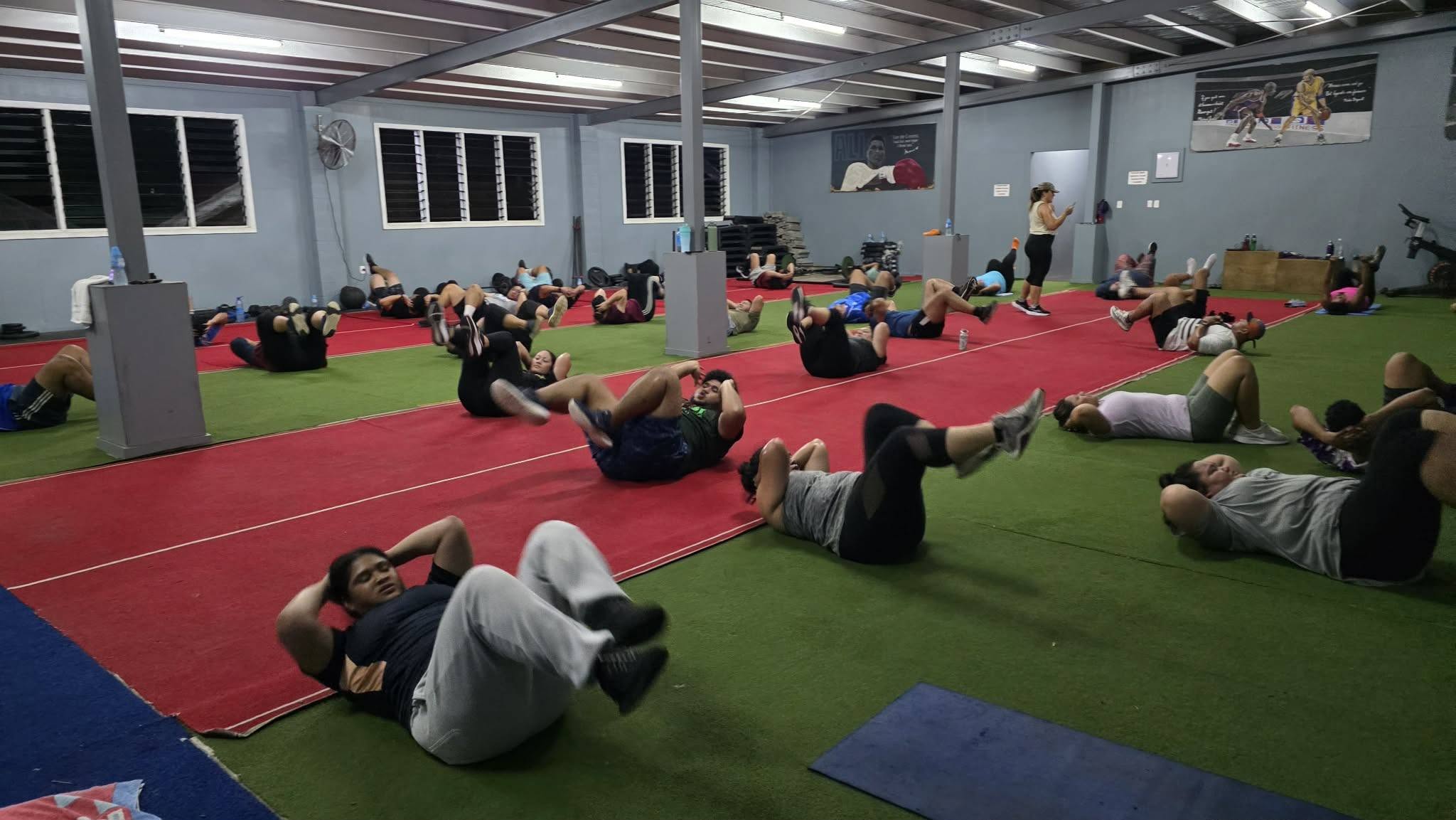 Participants exercising on mats in a fitness centre