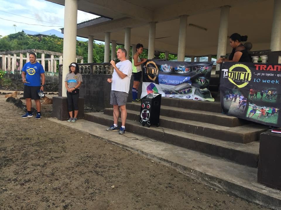A speaker addressing participants at a community event