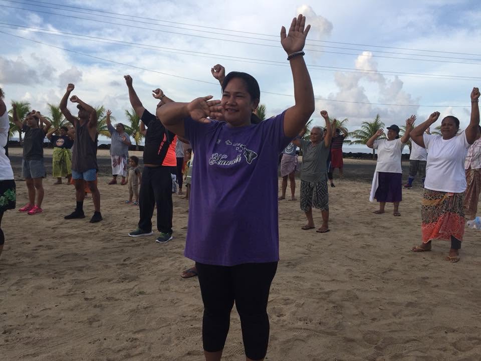 Participants raising their arms during outdoor exercise