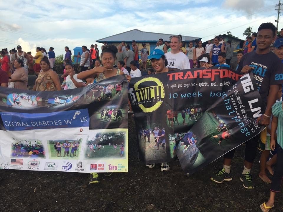 Community participants holding health programme banners